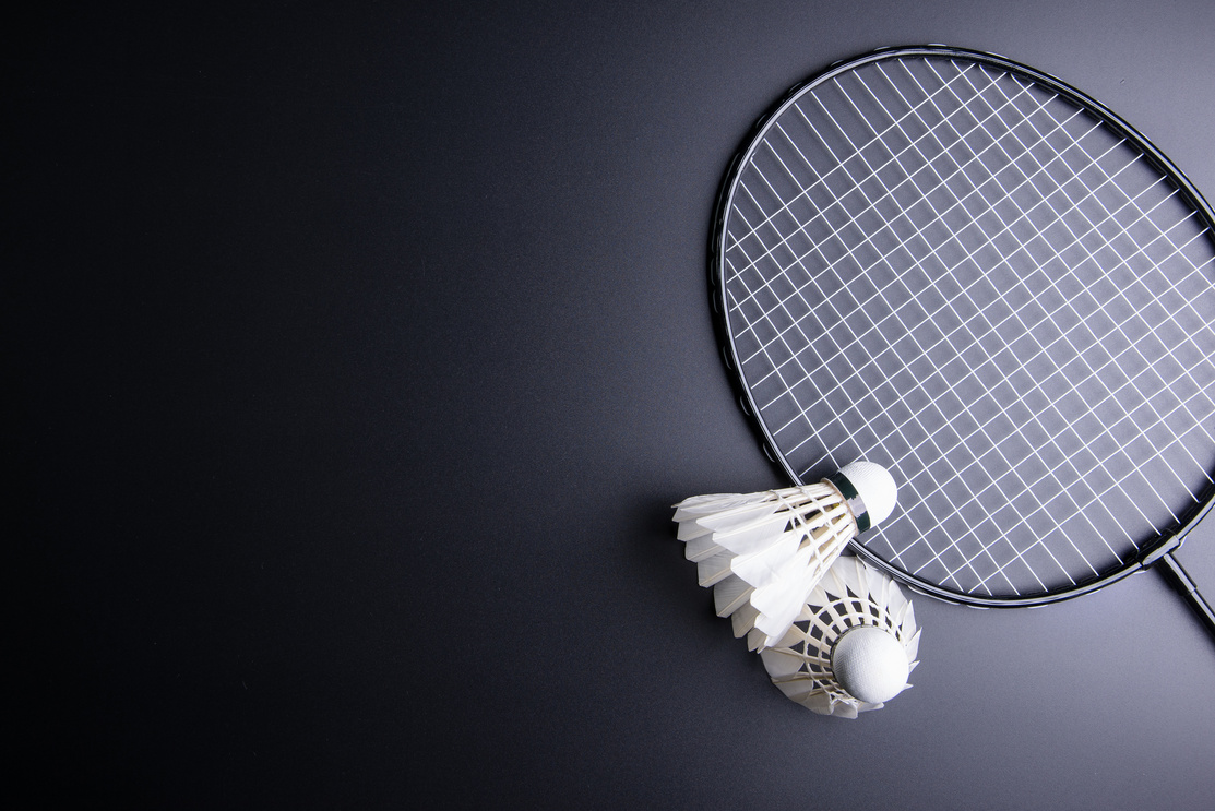 Two shuttlecocks and badminton racket on black background.Sport concept, Copy space image for your text.